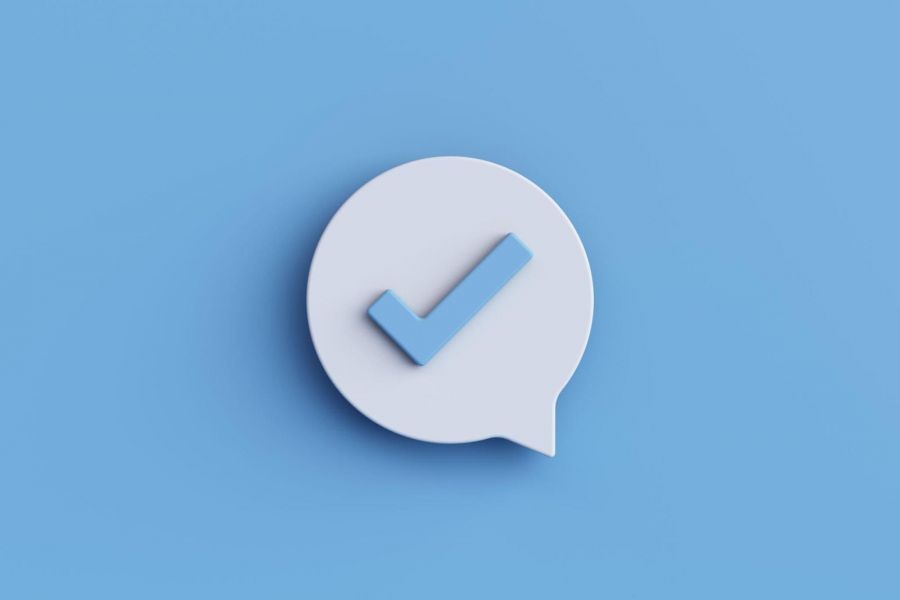 3D check mark in speech bubble on blue background