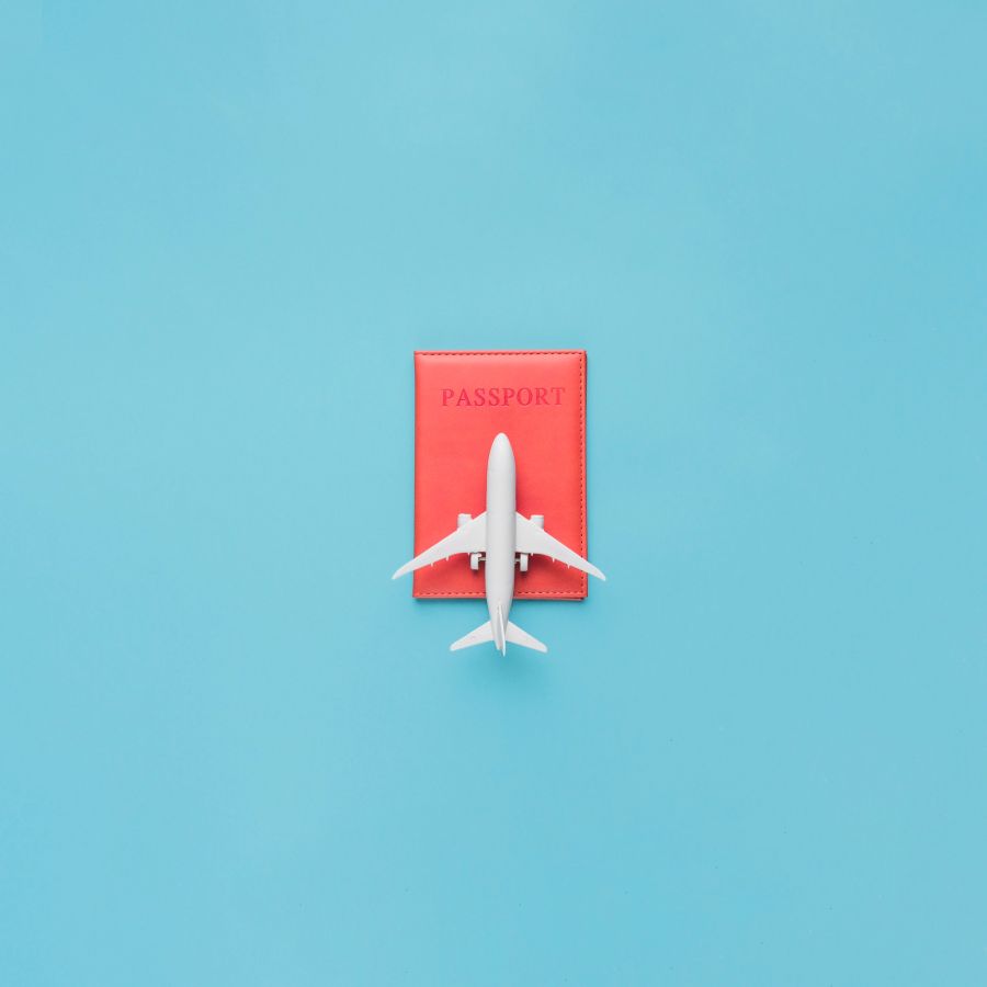 Plane and passport on blue background