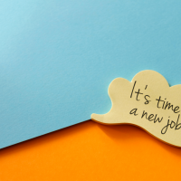 A yellow sticky note reading, 'Time for a new job' against a blue-orange backdrop