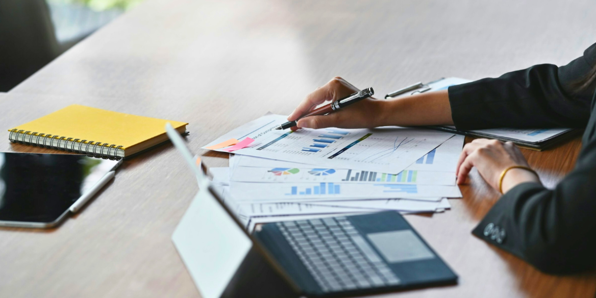 a close-up of a person reviewing financial documents