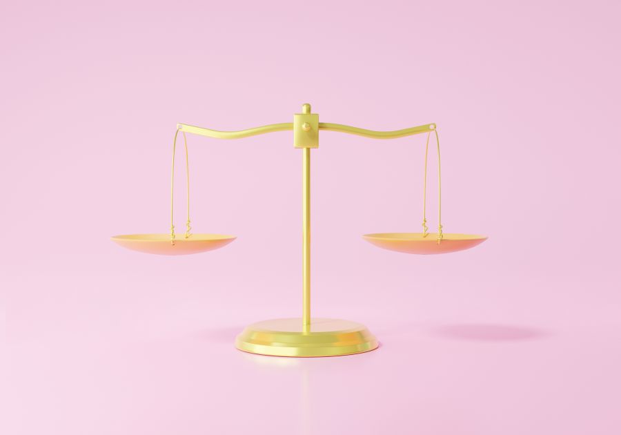 image of 3d golden scales on pink background