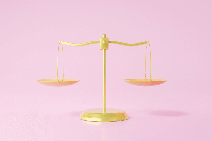 image of 3d golden scales on pink background