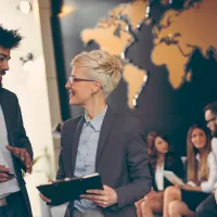 people in office with world map in the background