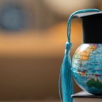 a graduation cap perched atop a miniature globe