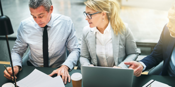 male and female colleagues discussing figures