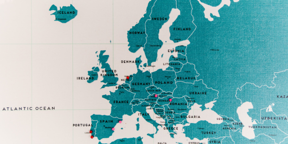 Teal-coloured  map of Europe and parts of Africa and the Middle East with labelled countries and small red markers, set on a light grid background.