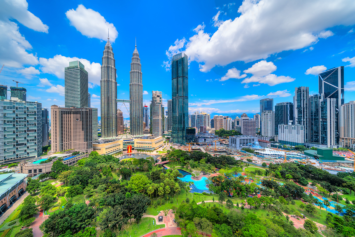 A Malaysian city with tall buildings and trees