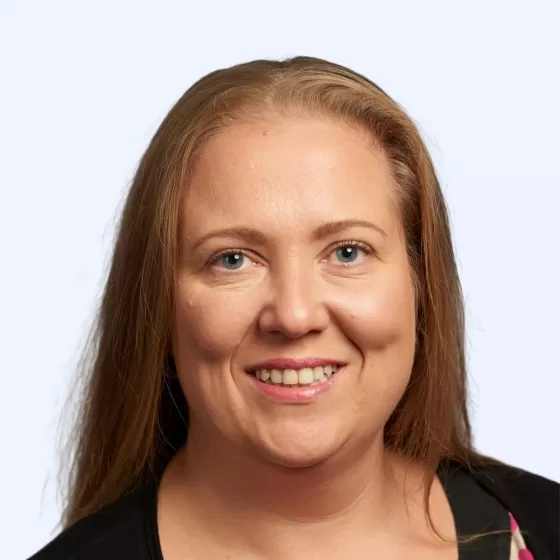 Joanna Hart Headshot with Light Blue Background