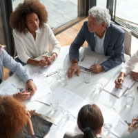 a group of diverse business people sitting around a table