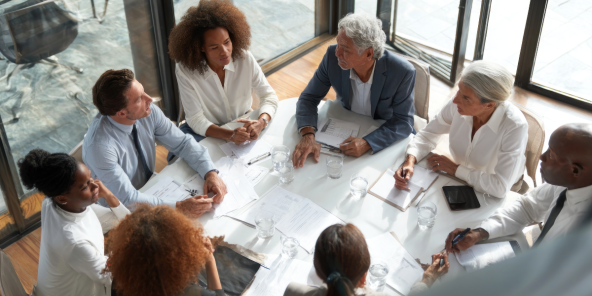 a group of diverse business people sitting around a table