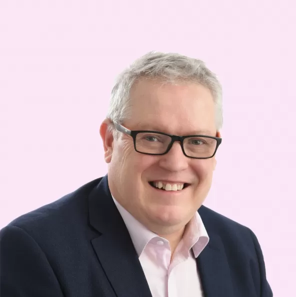 Chris Williams Headshot with Light Pink Background