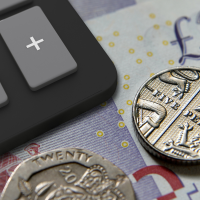 Closeup of a £20 note and coins