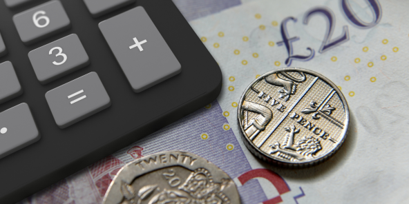 Closeup of a £20 note and coins