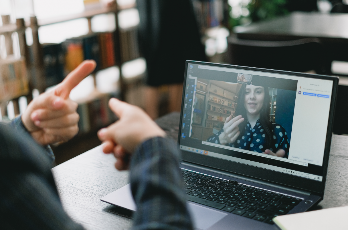 A young Caucasian lady virtually learning sign language