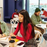 start-up team members in discussion while drinking coffee