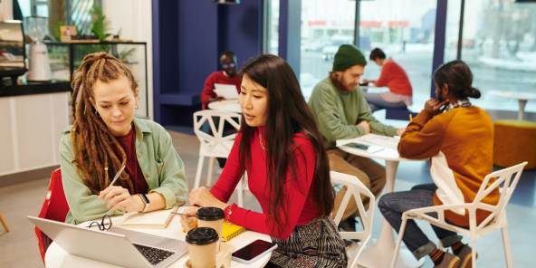 start-up team members in discussion while drinking coffee