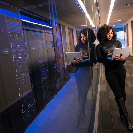 woman standing with laptop