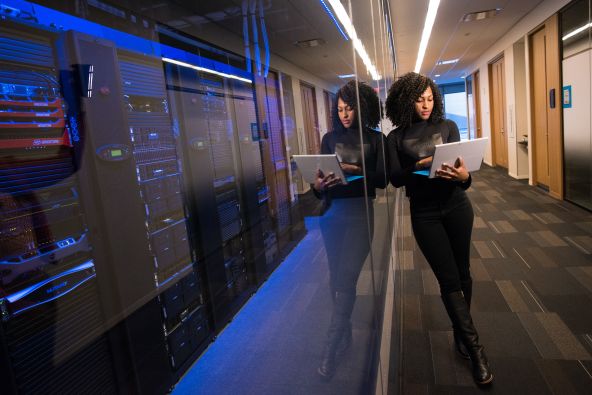 woman standing with laptop