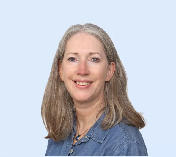 Teresa Lewis Headshot with Blue Background