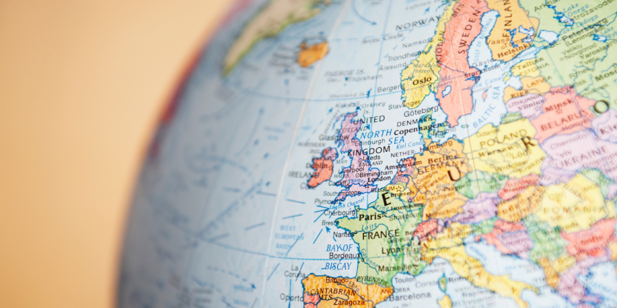 A closeup of Europe on the globe against a yellow background