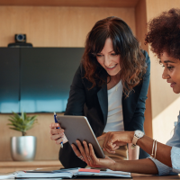 two female workers in discussion at the office
