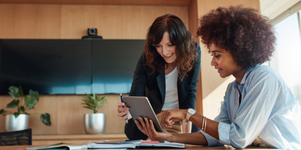 two female workers in discussion at the office