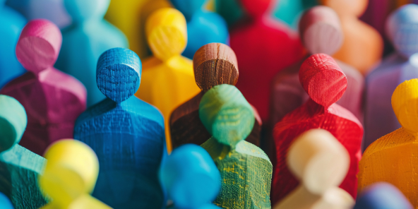 colourful wooden figurines lined up in a crowd