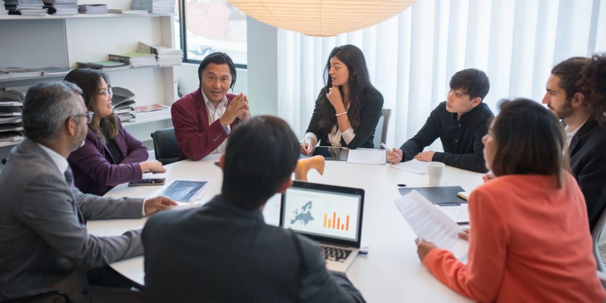 asian team in a meeting discussing european prospects 