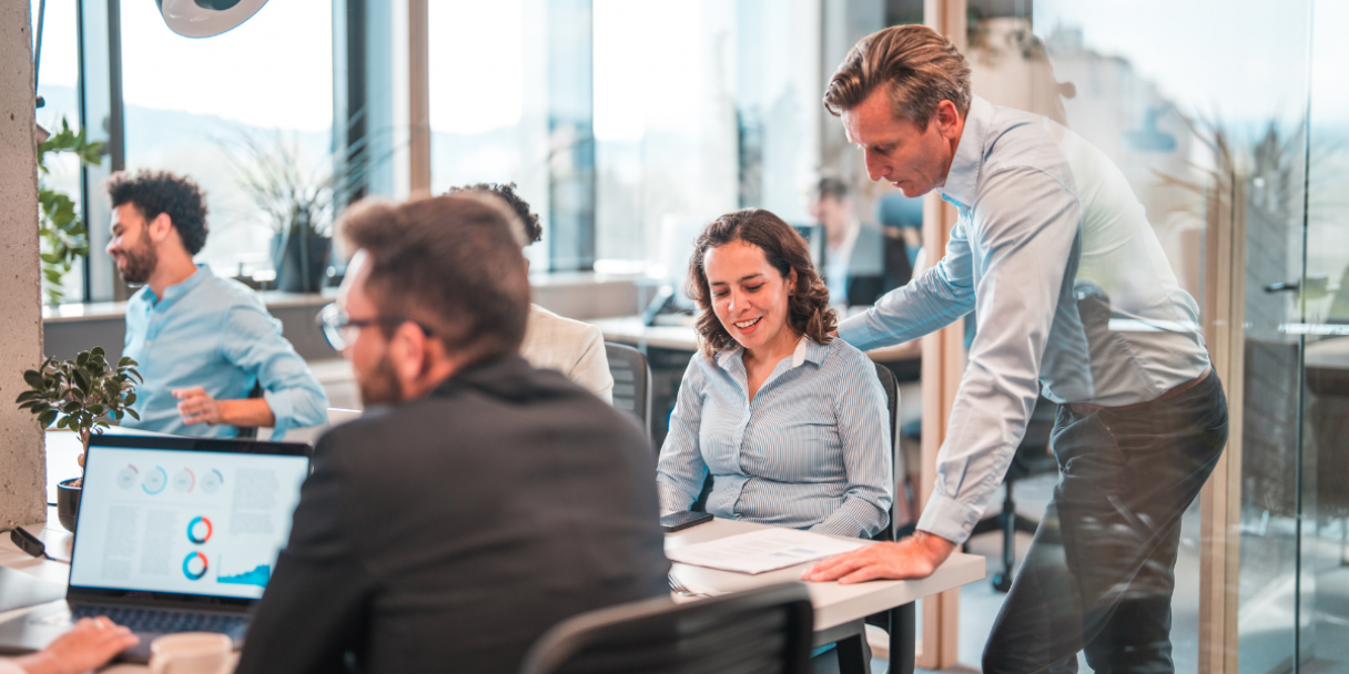 male middle-aged manager helping a colleague