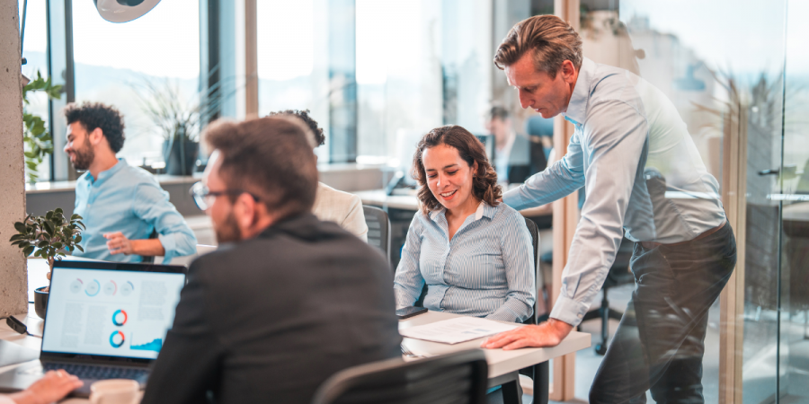 male middle-aged manager helping a colleague
