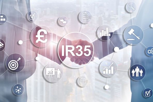A close-up of businessmen hands shaking, with an overlay reading 'IR35'