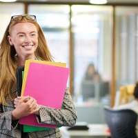 smiling legal intern holding files