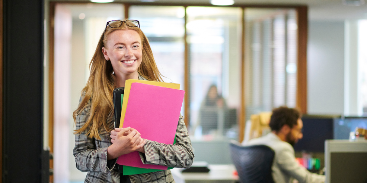 smiling legal intern holding files
