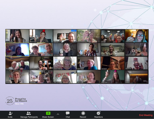 Mauve's virtual 25th birthday party displayed on a grid of video call participants, many holding drinks and wearing party hats