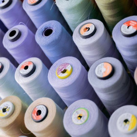 Closeup of mauve-coloured thread spools
