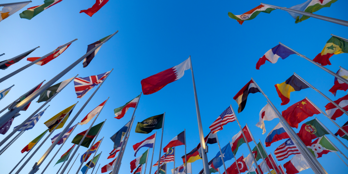 a collection of country flags against a blue sky