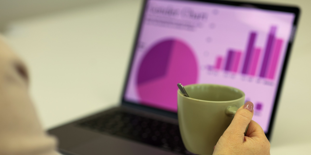 closeup of a lady looking at charts on a laptop screen