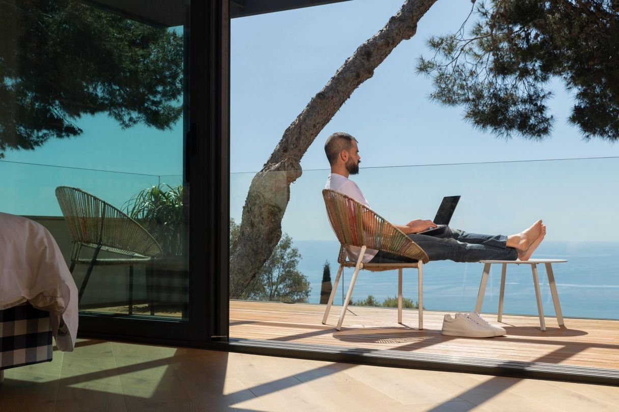 man working on laptop remotely abroad