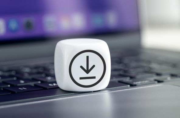 laptop and dice with download symbol