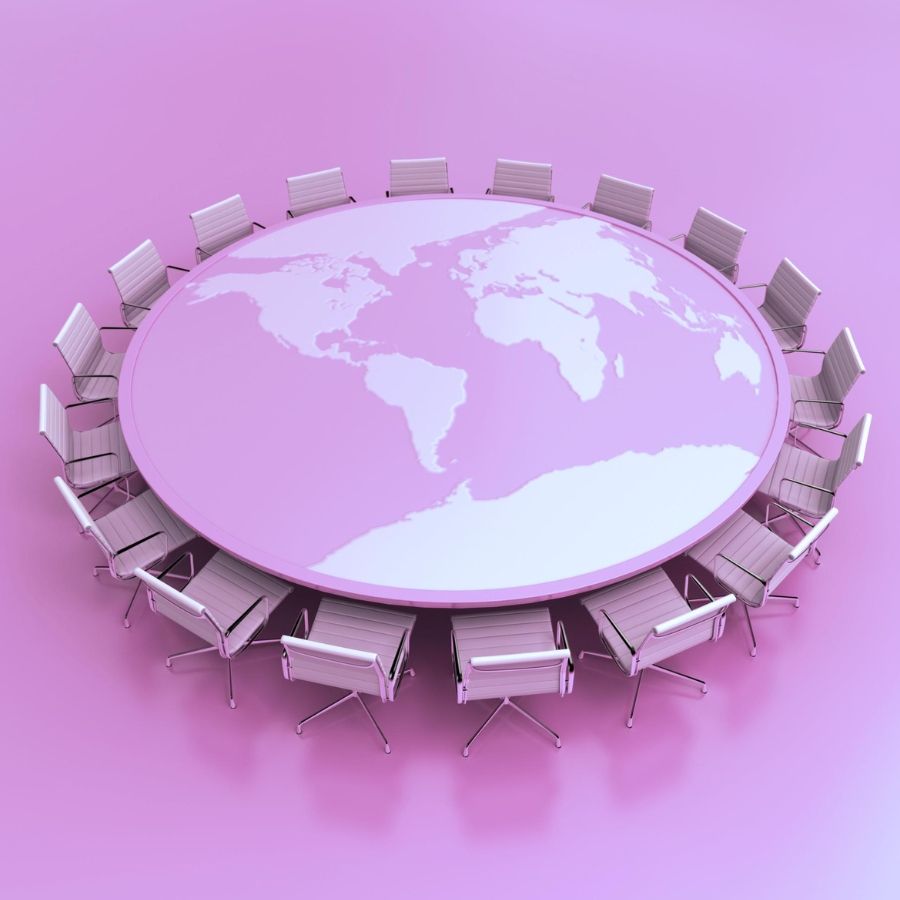 A round table with a world map, surrounded by chairs map on it