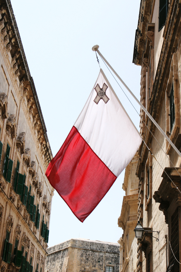 Vertical bicolour of equal stripes of white on the hoist side and red on the fly side, featuring the George Cross edged in red in the upper canton