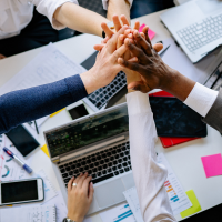 Colleagues high-fiving in a meeting