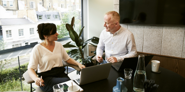 In-office male and female colleagues in discussion
