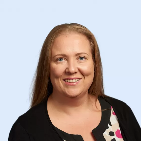 Joanna Hart Headshot with Blue Background