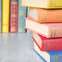 stack of hardcover, brightly coloured books