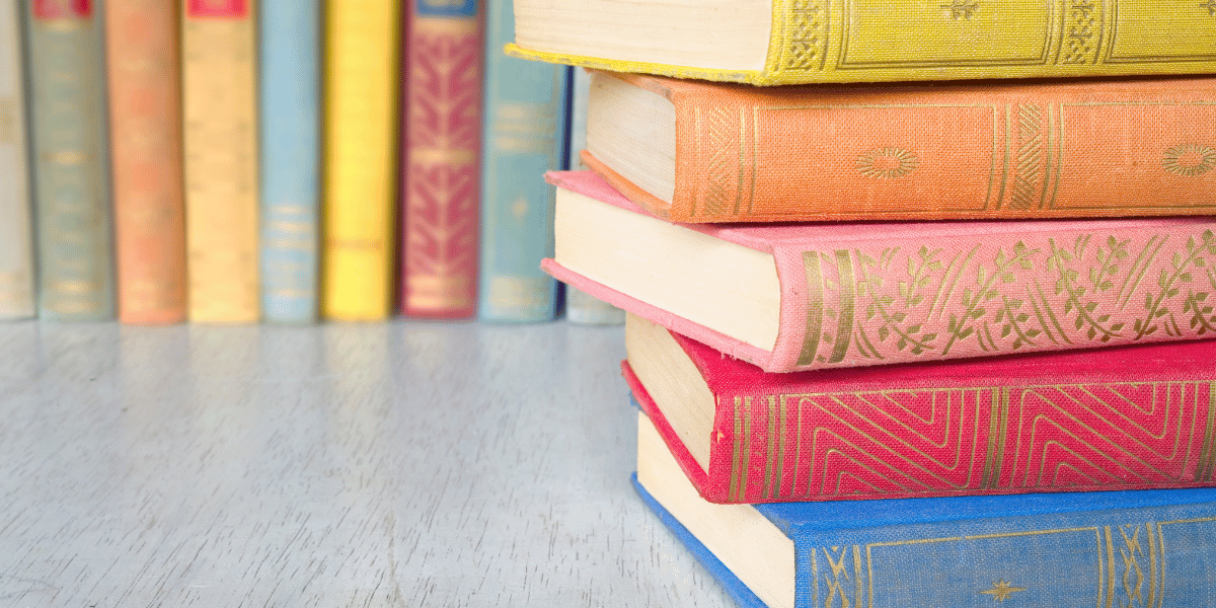 stack of hardcover, brightly coloured books