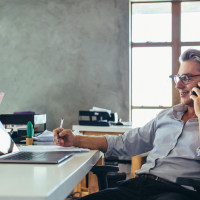 Businessman talking on the phone while at his desk