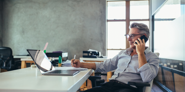 Businessman talking on the phone while at his desk