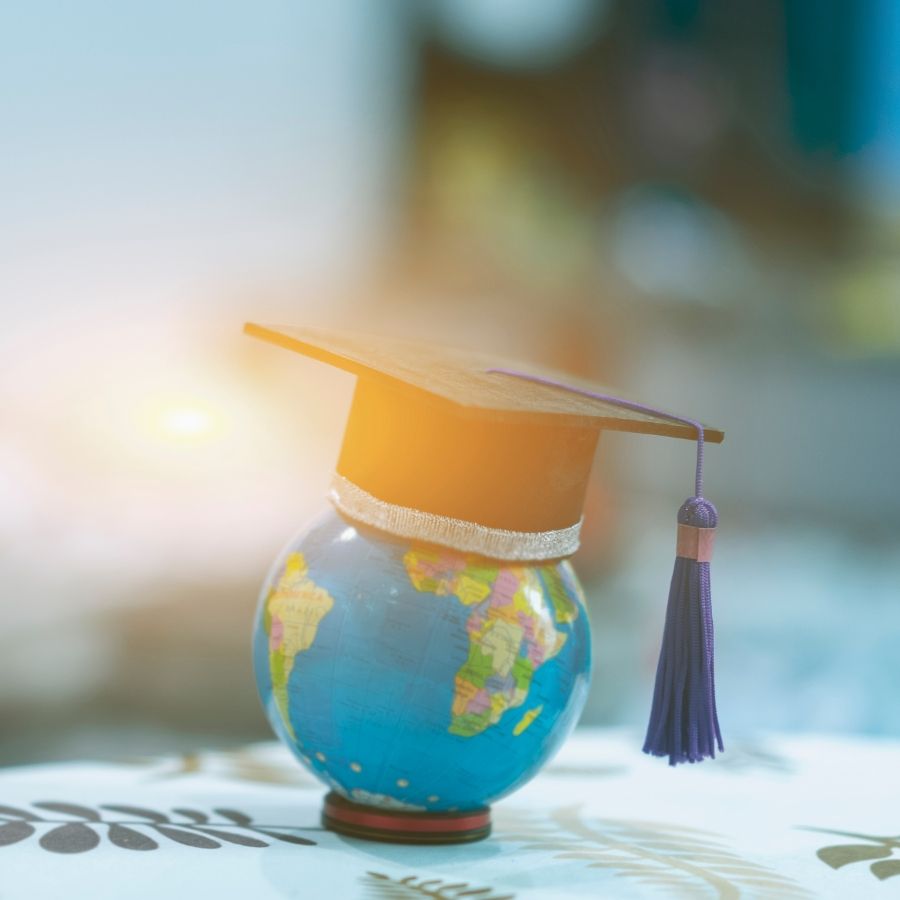 a graduation cap atop a globe
