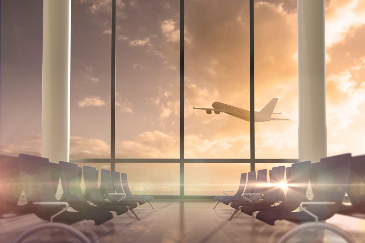 airplane-flying-past-departures-lounge-window